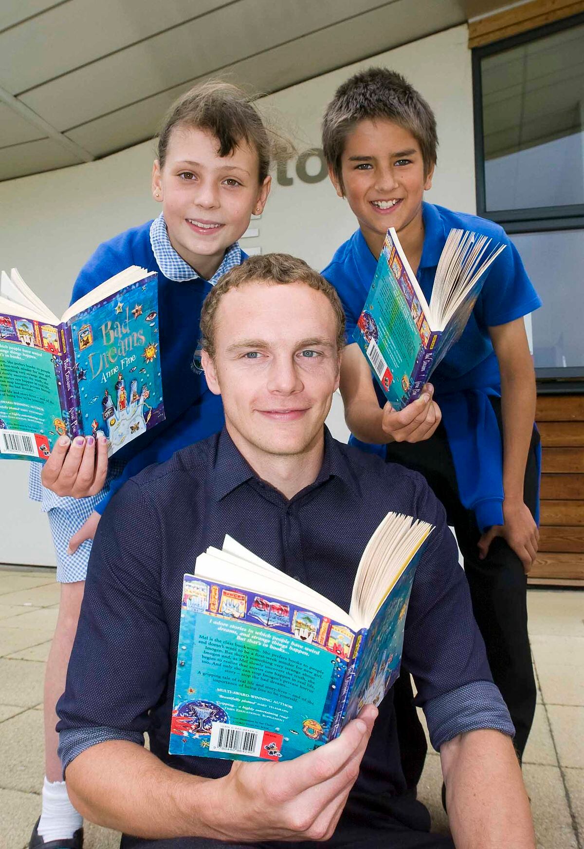 SAME DAY Sam Aiston, who has started his teaching roll at Bicton Primary School, pictured with pupils Chloe Jones, 11, and DanAdams, 11.PIC PETER SHAH