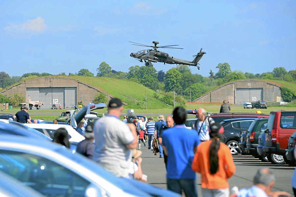 The Apache helicopter with Prince Harry comes in to land watched by some of the 50,000 crowd at the show