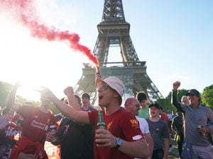 Liverpool football fans near the Eiffel Tower in Paris ahead of Saturday’s Uefa Champions League Final between Liverpool FC and Real Madrid (Jacob King/PA)
