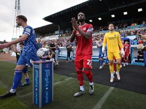 Chey Dunkley leads Shrewsbury Town out before their clash with Carlisle (AMA)