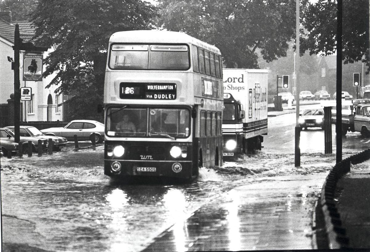 A bus splashes through Thompson Avenue, Wolverhampton, after a flash flood.