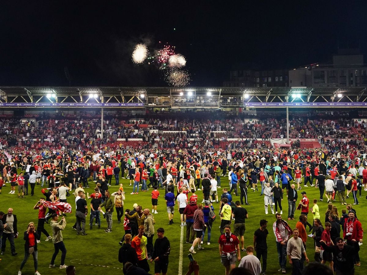 Nottingham Forest fans celebrate on the pitch after they reached the play off final