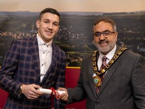 Liam Davies is presented with his title by Mayor, Raj Mehta