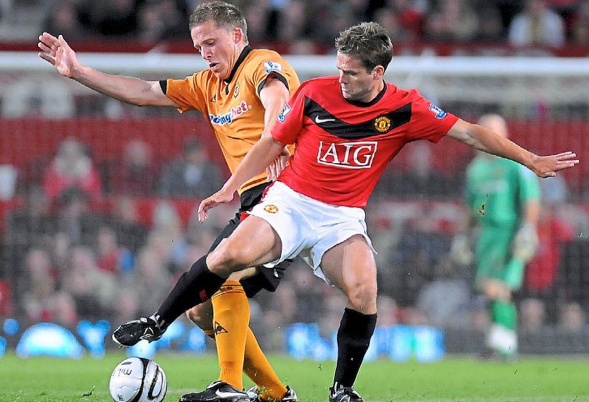 Christophe Berra tangles with Michael Owen at Old Trafford after winning promotion to the Premier League