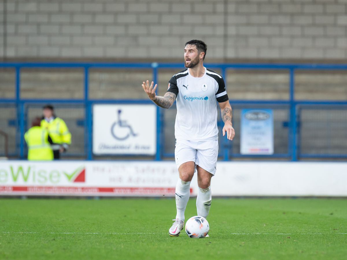Matty Brown (4) (AFC Telford United Defender)has the ball at miway line.