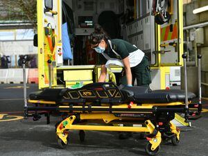 A paramedic cleans an ambulance