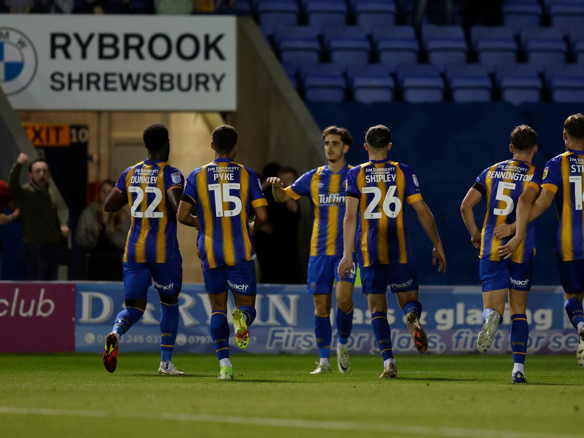 Tom Bayliss of Shrewsbury Town celebrates with his team mates after scoring a goal to make it 2-2.