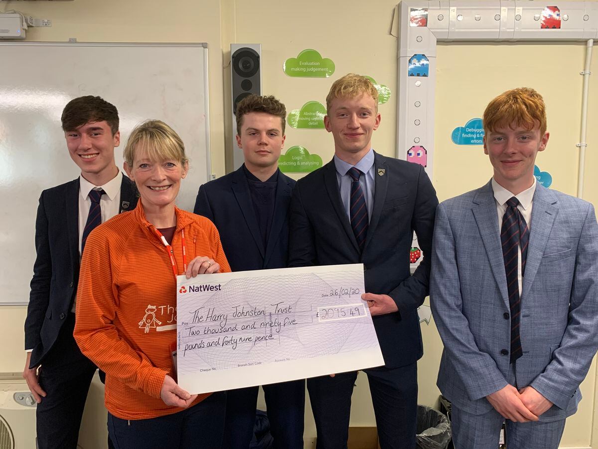OsBiz pupils presented the cheque to Sally Johnson
