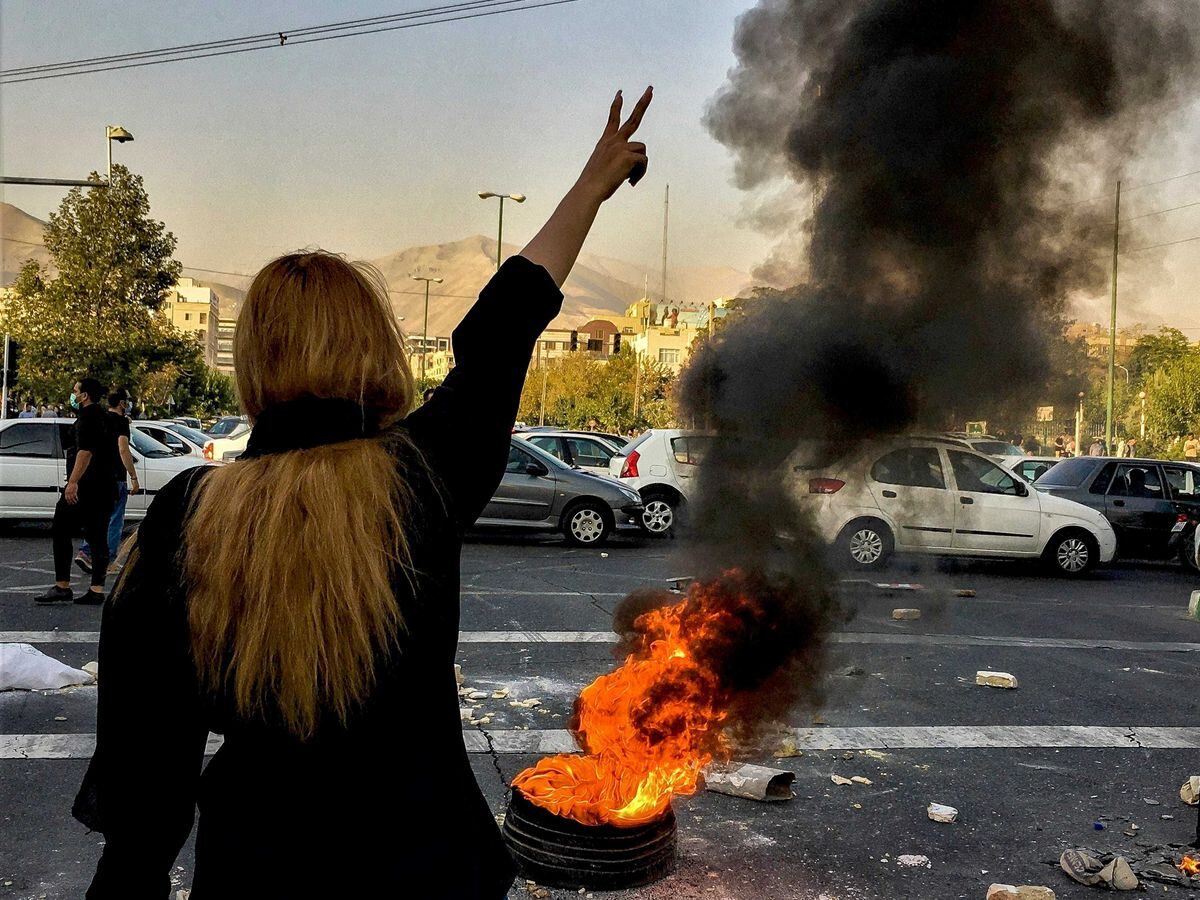 Iranians protest the death of 22-year-old Mahsa Amini after she was detained by the morality police, in Tehran in October
