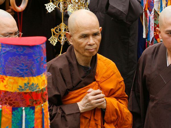 Thich Nhat Hanh, centre, arrives for a great chanting ceremony