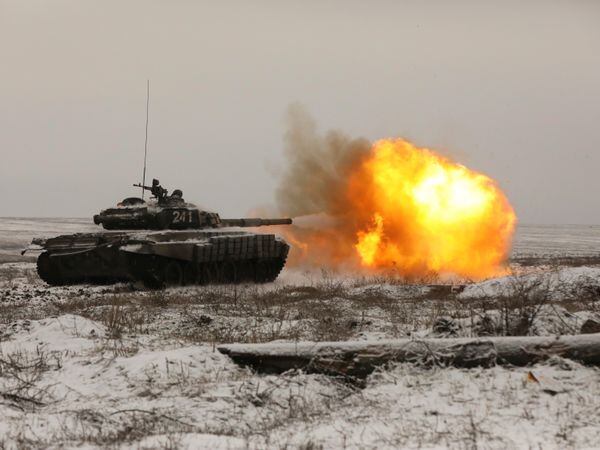 A Russian tank fires as troops take part in drills at the Kadamovskiy firing range in the Rostov region in southern Russia