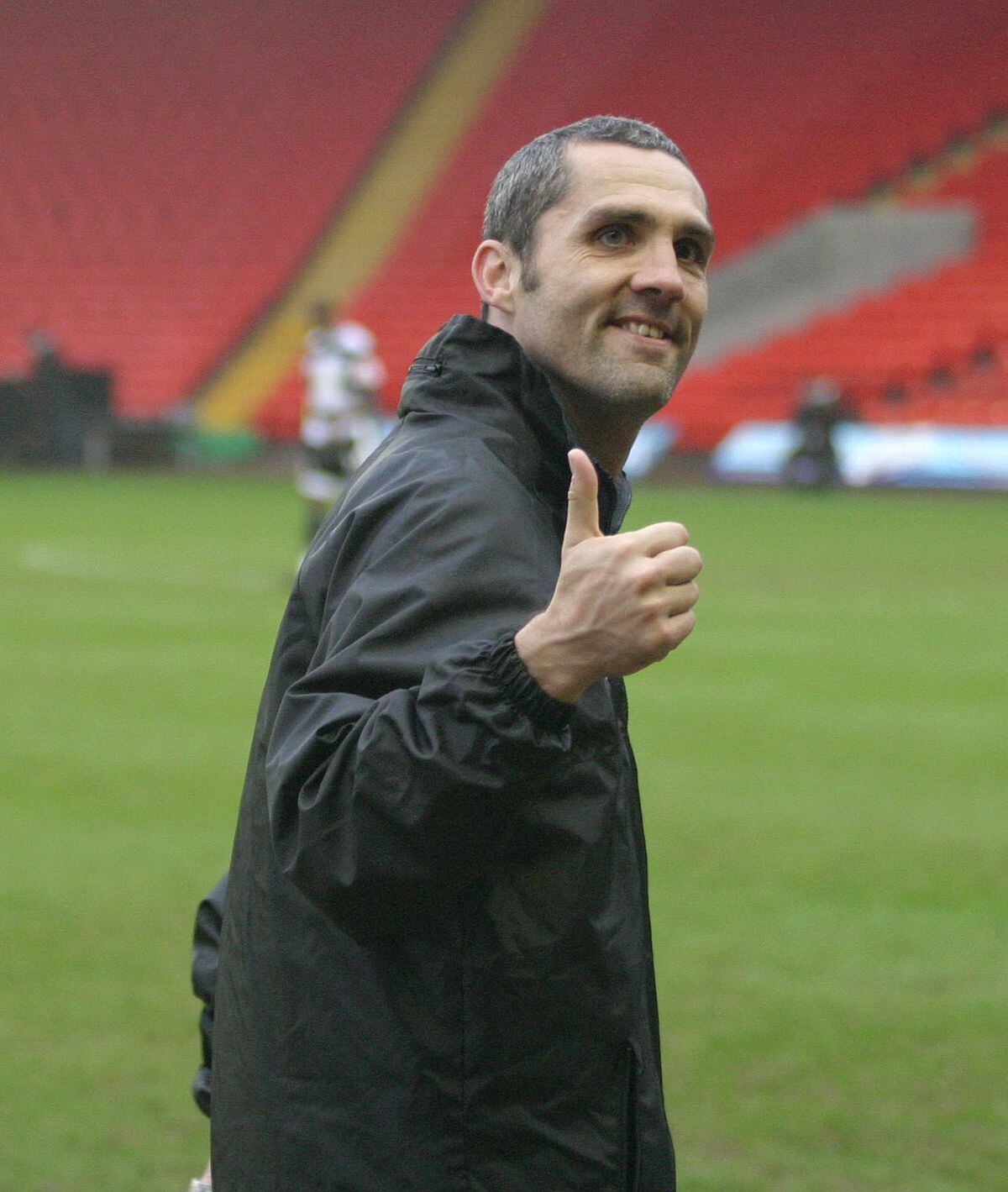 Harriers boss Stuart Watkiss gives a thumbs up after the win against Darlington
