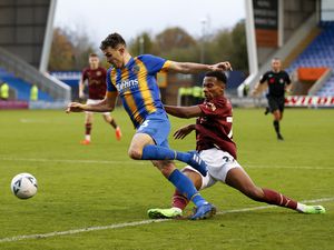 Tom Flanagan of Shrewsbury Town is fouled by Manny Duku of York City to win a penalty.