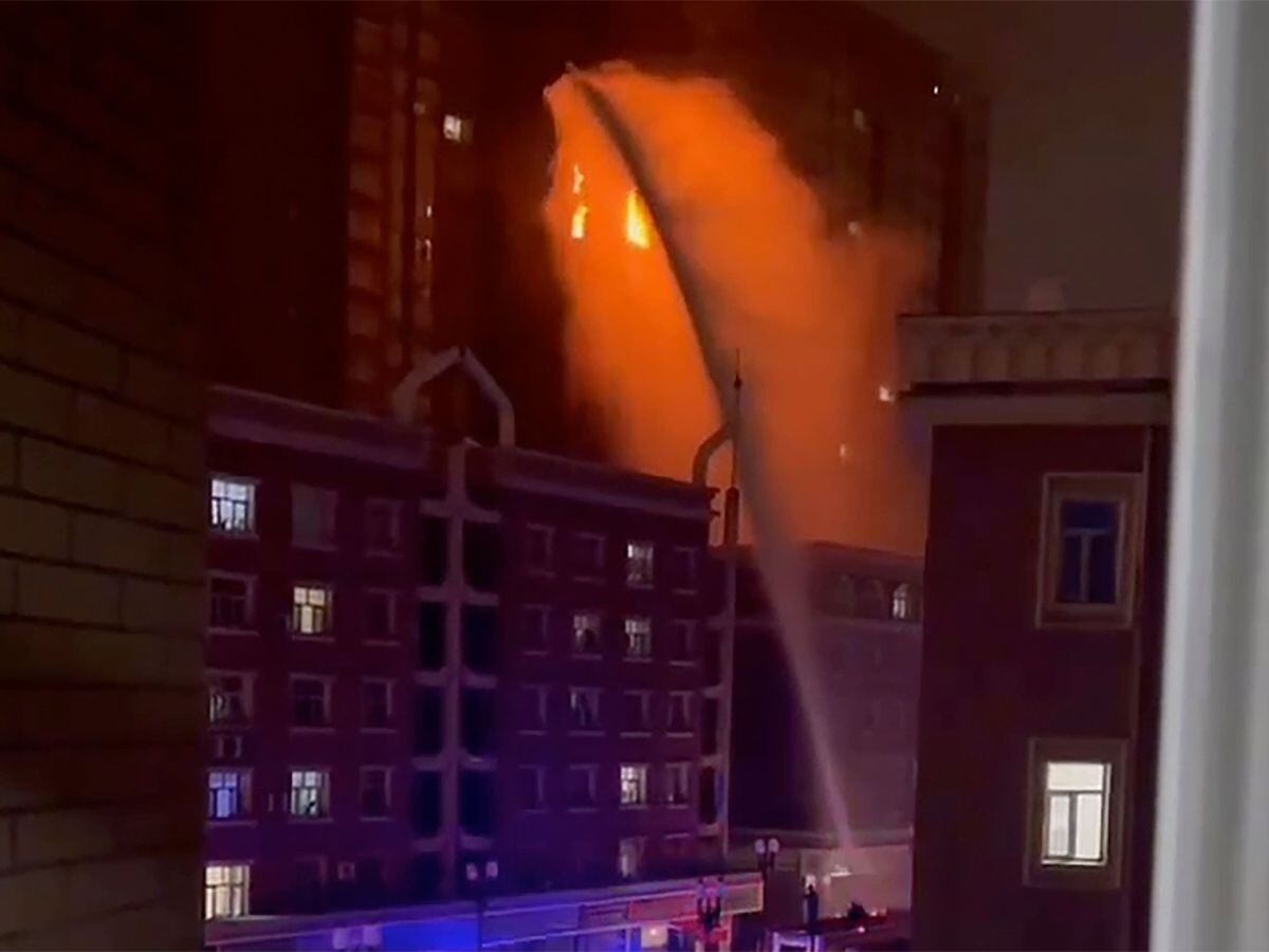 Firefighters spray water on a fire at a residential building in Urumqi in western China’s Xinjiang Uyghur Autonomous Region