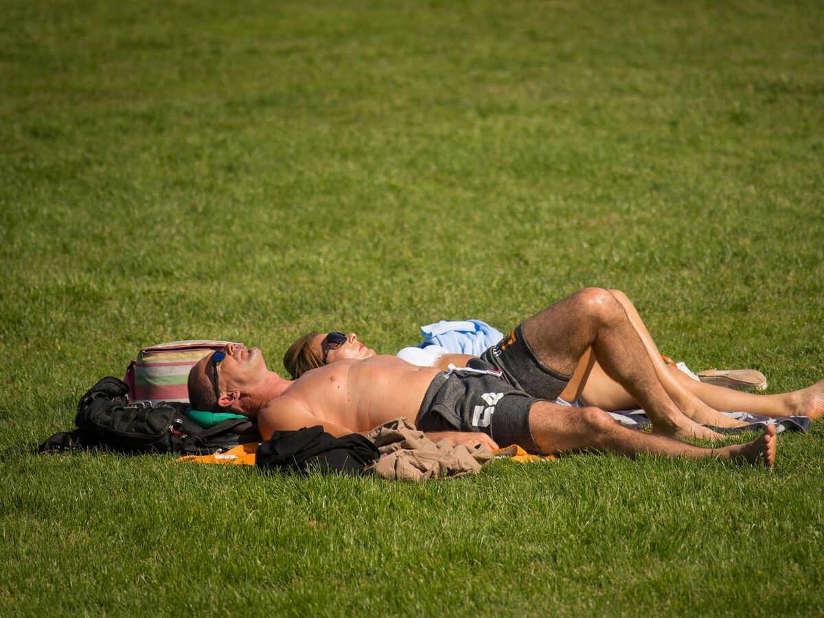 People enjoy the warm and sunny weather. Photo: Dominic Lipinski/PA Wire ..