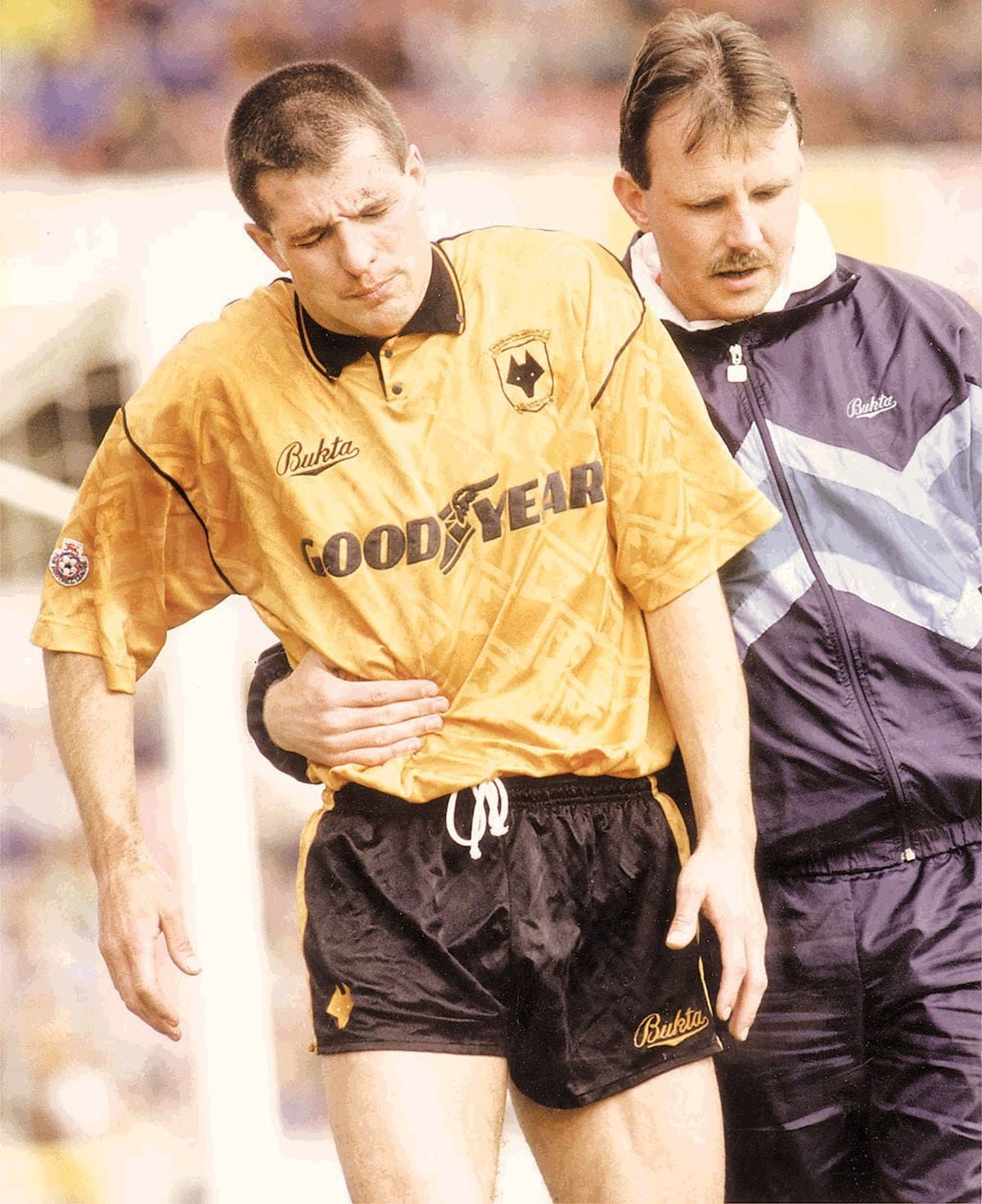 Steve Bull is helped off the pitch by physio Paul Darby in the 1991/92 season