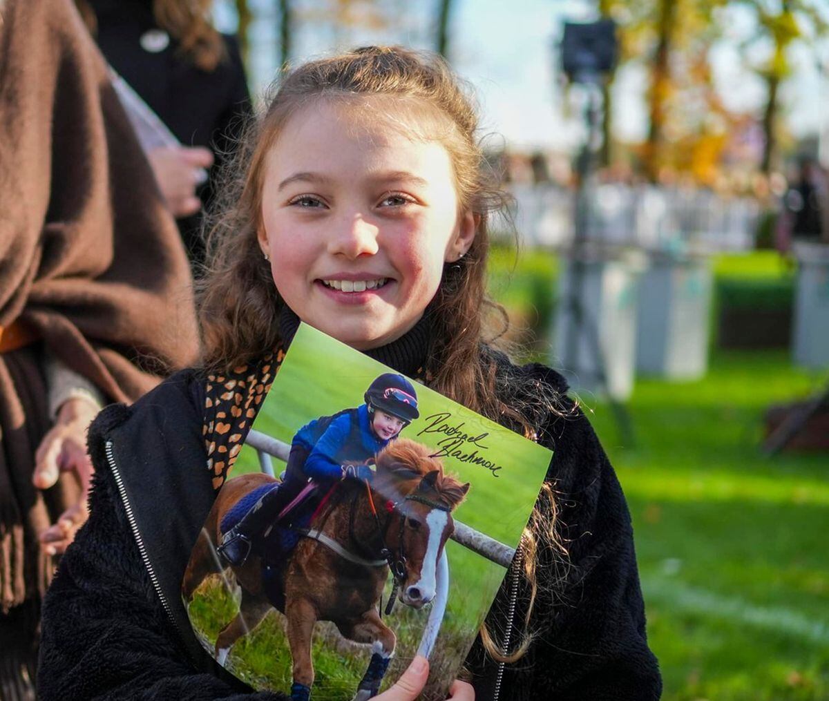10-year-old Lexi with a signed photo of her hero, Rachael Blackmore.  Photo: Ryan Day Photography.