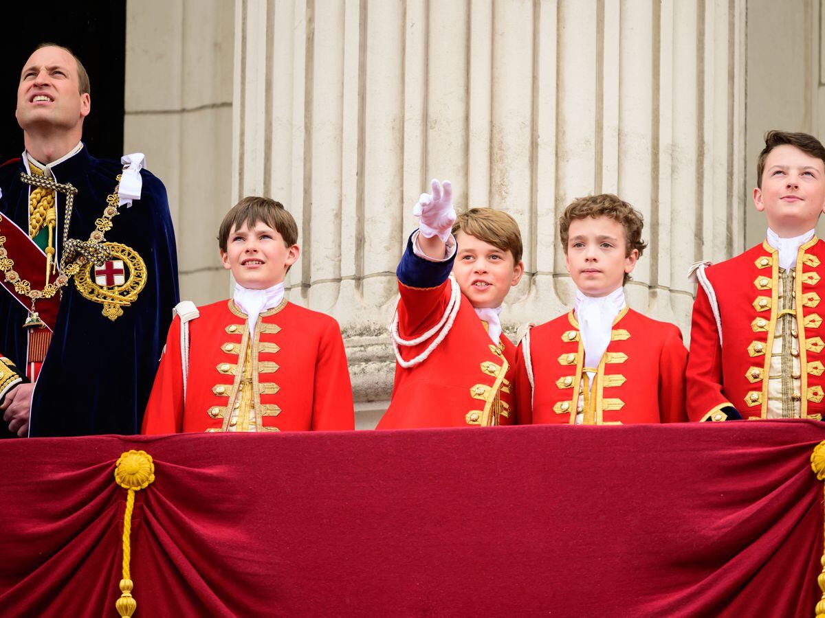 The Prince of Wales and Prince George with the King’s Pages of Honour on the balcony of Buckingham Palace following the coronation (Leon Neal/PA)