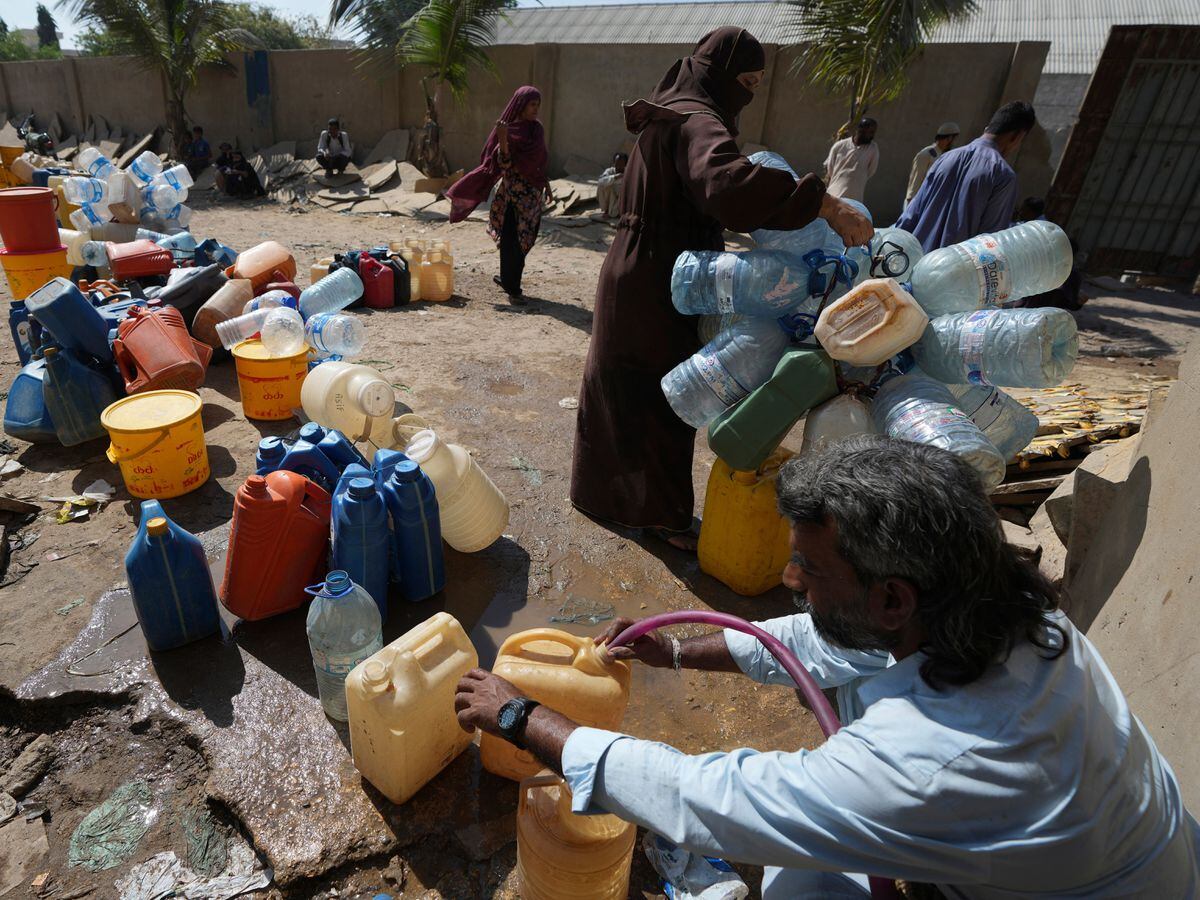 People get drinking water from a water-collecting point in Karachi, Pakistan