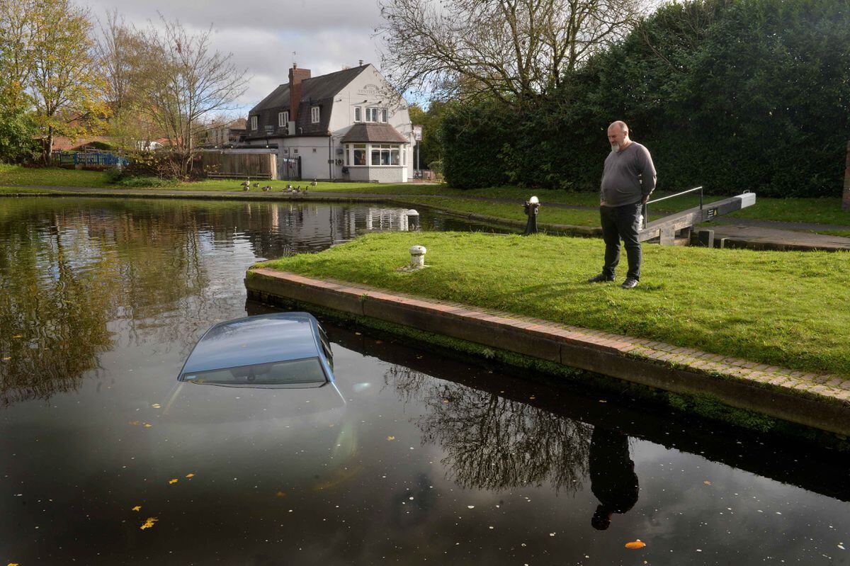 Kevin Davenport looking at the car dumped in the Brierley Hill canal