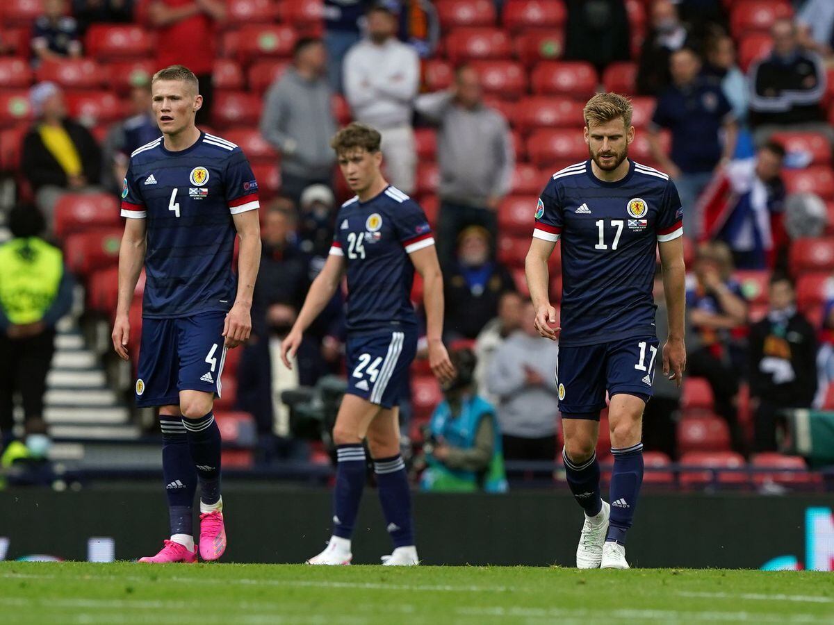 Scotland’s Scott McTominay, Jack Hendry and Stuart Armstrong stand dejected at Hampden Park