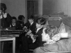 John and George strum away, watched by Roger and, foreground, Andre.