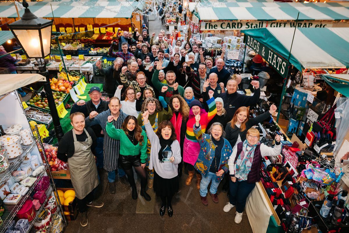 Facilities Manager Kate Gittins and traders celebrating Shrewsbury Market being named Britain's favourite market
