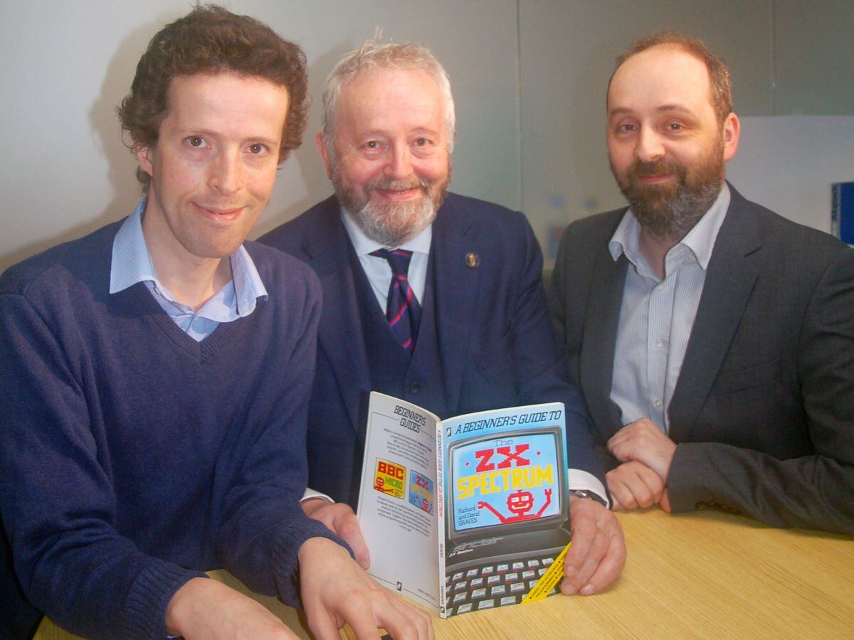 Philip, Richard and David Graves with one of the users' guides to computers they wrote in the 1980s.