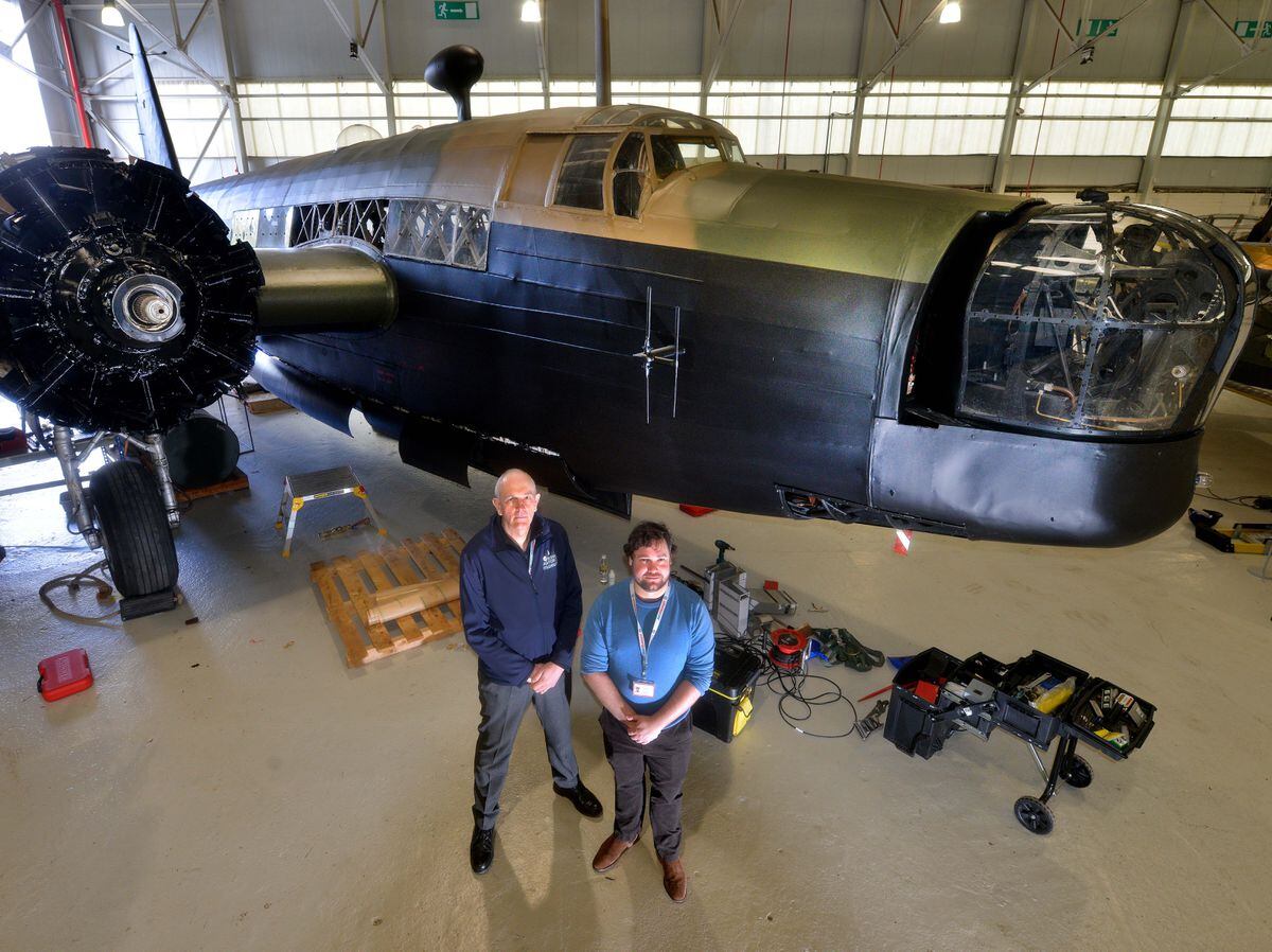 Curator Tom Hopkins (right), conservation centre manager Darren Priday and the Wellington bomber