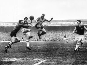 Wolverhampton Wanderers goalkeeper Malcolm Finlayson saves from Aston Villa's centre-forward Gerry Hitchens (centre) during the FA Cup semi-final held at The Hawthorns. On the right is Wolves left-half Ron Flowers..