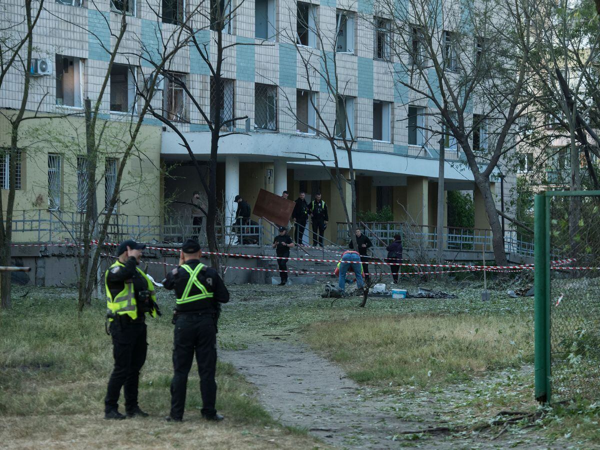 Police inspect a building damaged by a Russian night attack in Kyiv, Ukraine, on Thursday