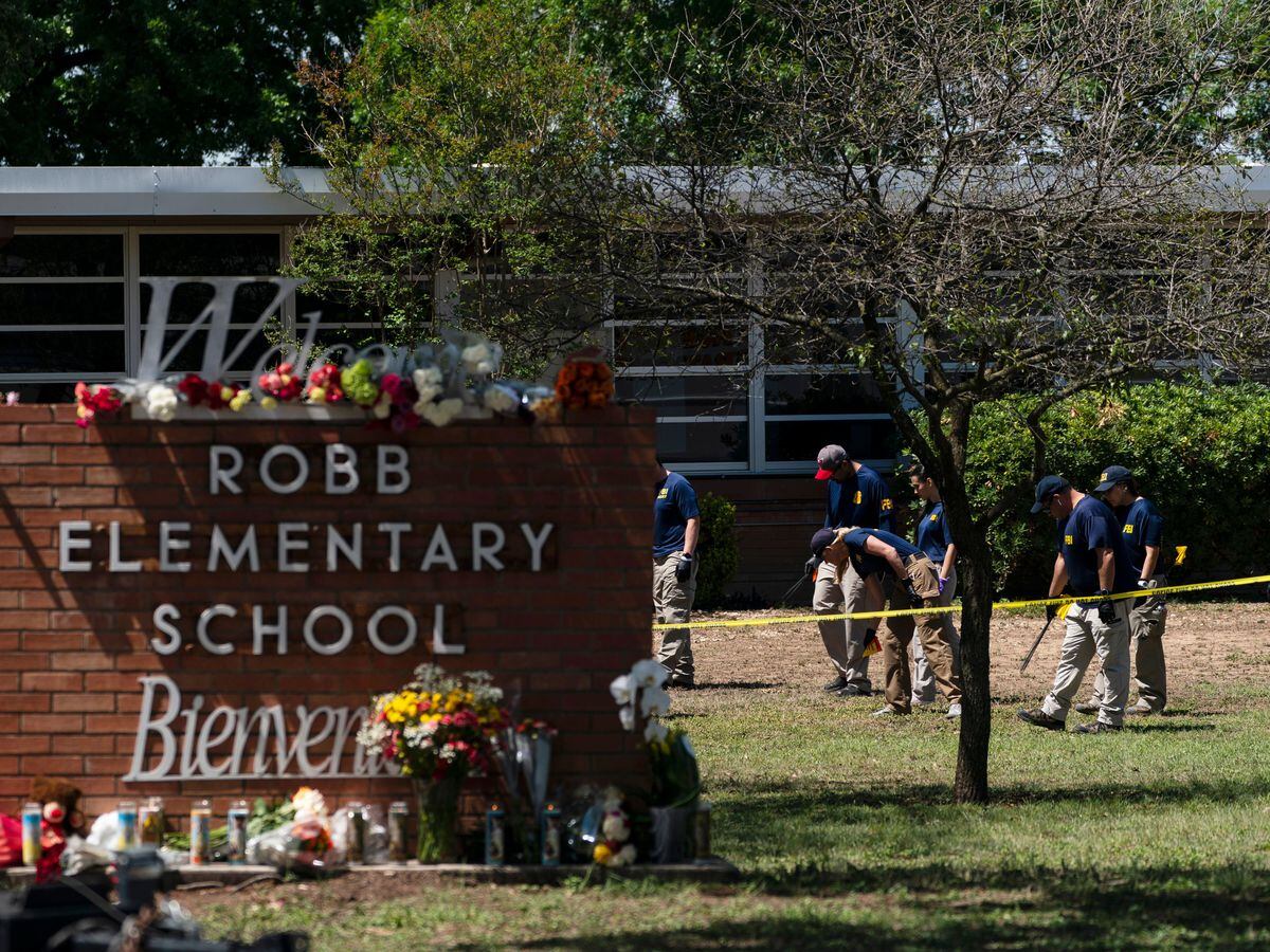 Investigators search for evidence outside Robb Elementary School in Uvalde, Texas