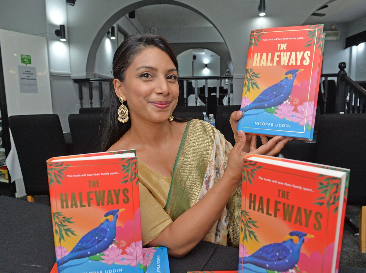 Novelist Nilopar Uddin with her novel The Halfways