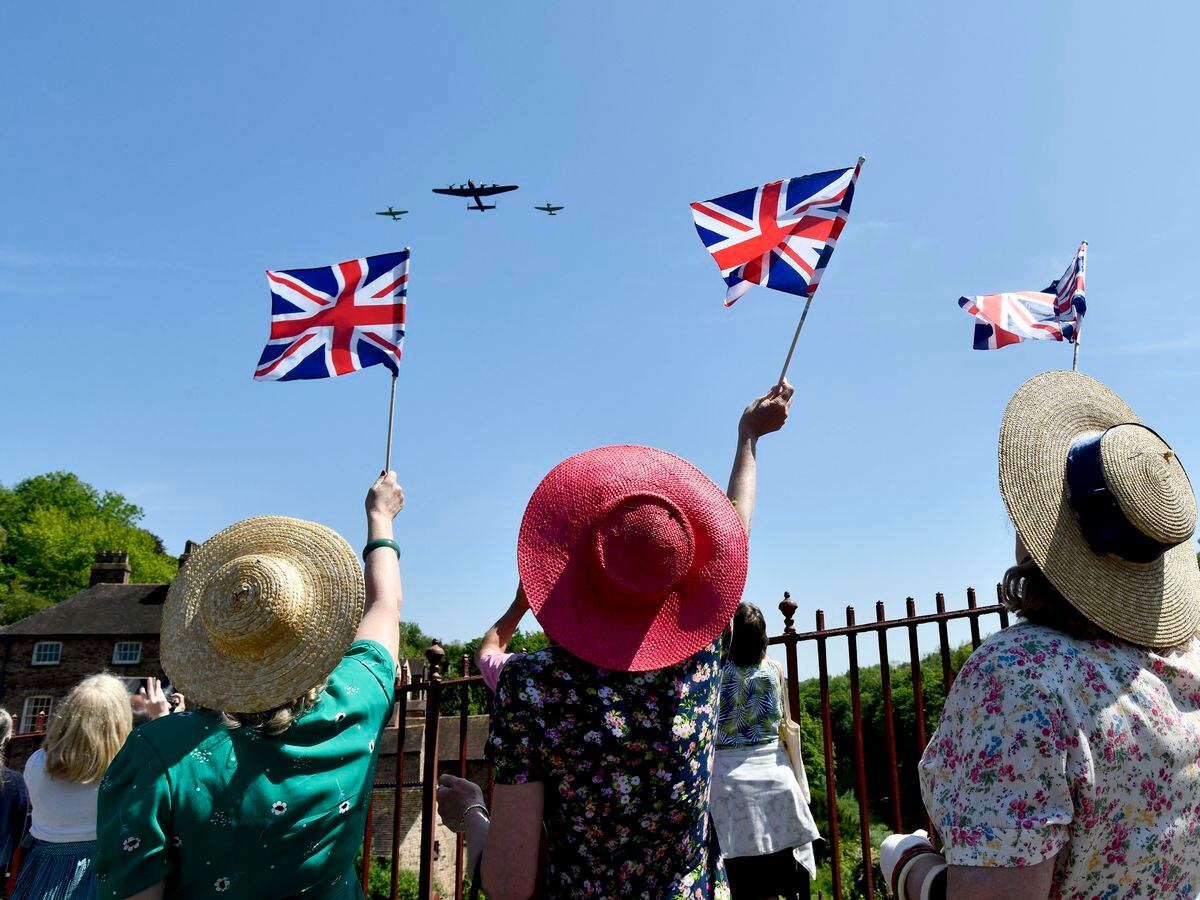 The Ironbridge World War Two Weekend. A flypast by a second world war Lancaster, Spitfire and Hurricane greeted by flag waving on the famous Ironbridge. Picture: Dave Bagnall
