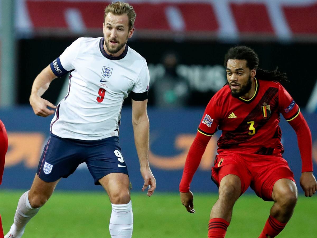 England's Harry Kane, centre, competes for the ball with Belgium's Axel Witsel, left, and Jason Denayer, right, during the UEFA Nations League soccer match between Belgium and England at the King Power stadium in Leuven, Belgium, Sunday, Nov. 15, 2020. (AP Photo/Francisco Seco).