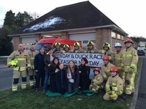 Bethan, her family and firefighters getting ready for the open day and charity duck race.