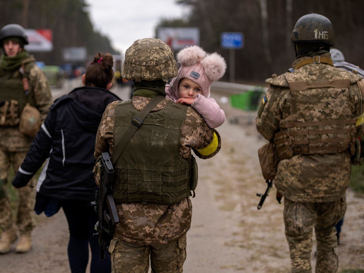 Soldiers carry baby