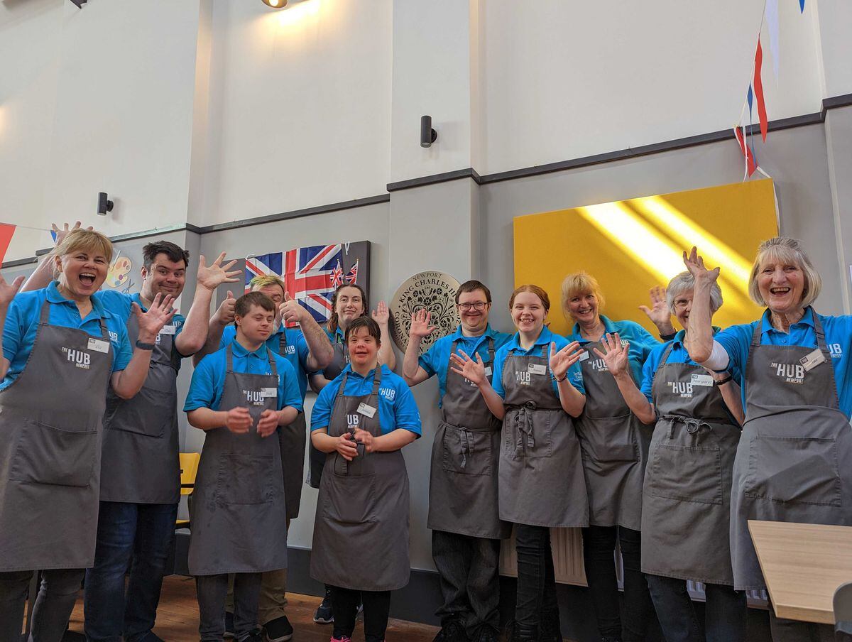Staff at The Hub in Newport, celebrate their new plaque