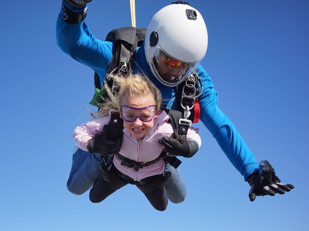Lola-Jo becomes the UK's youngest skydiver with instructor 'Magic Mike'