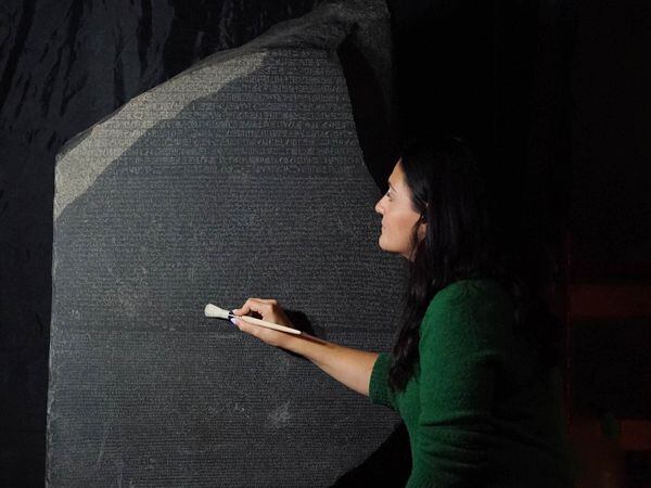 Senior conservator Stephanie Vasiliou prepares the Rosetta Stone