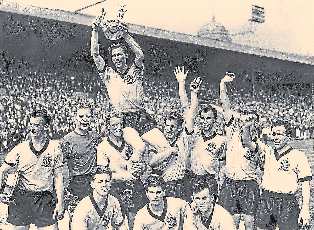 Wolves skipper Bill Slater lifts the FA Cup at Wembley. Ron Flowers can also be seen.