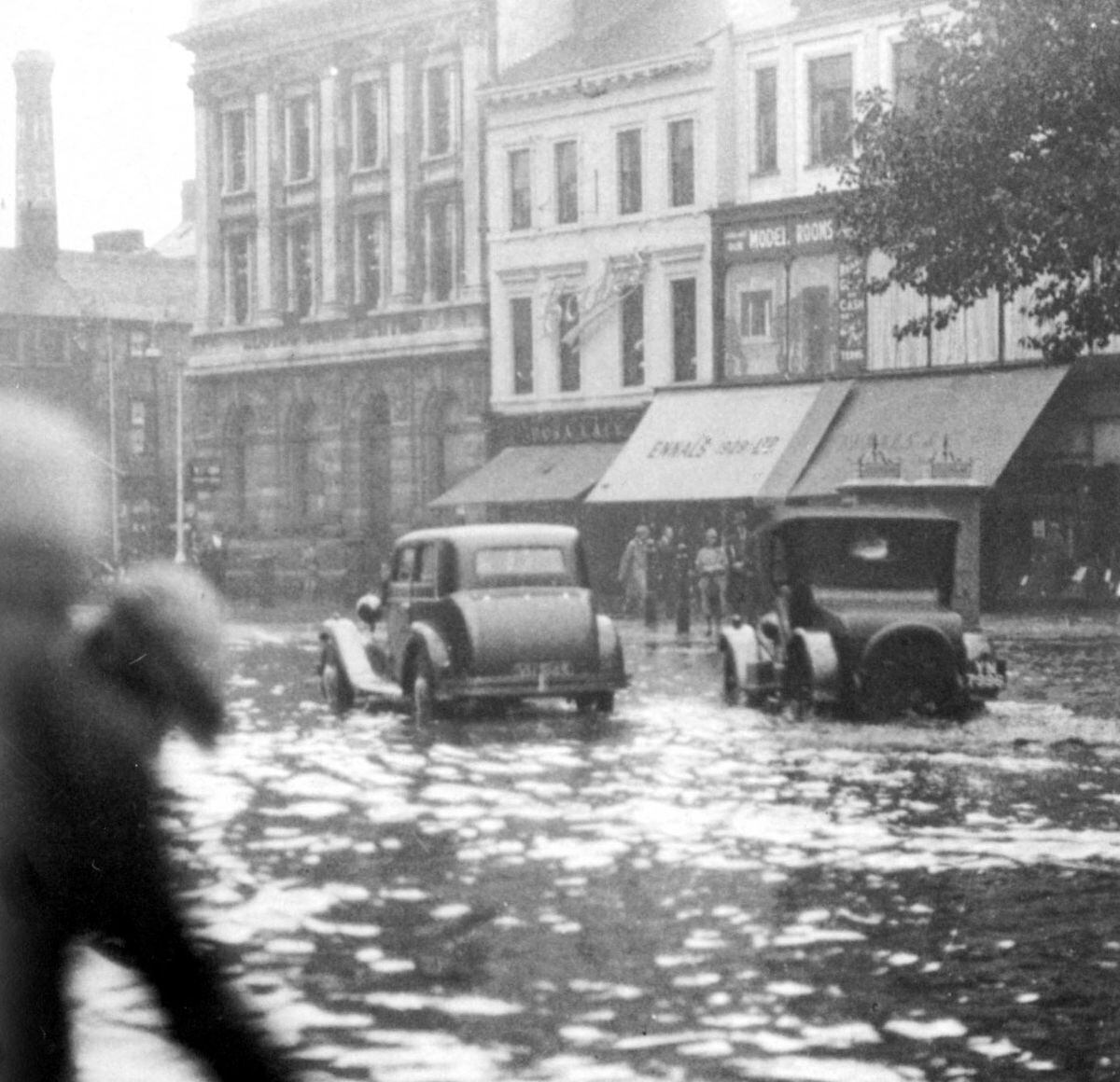 Flooded streets of Walsall. Based on the vintage of the cars it looks perhaps the 1920s.