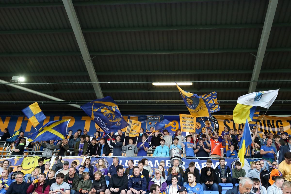 Shrewsbury Town fans waving flags. (AMA)
