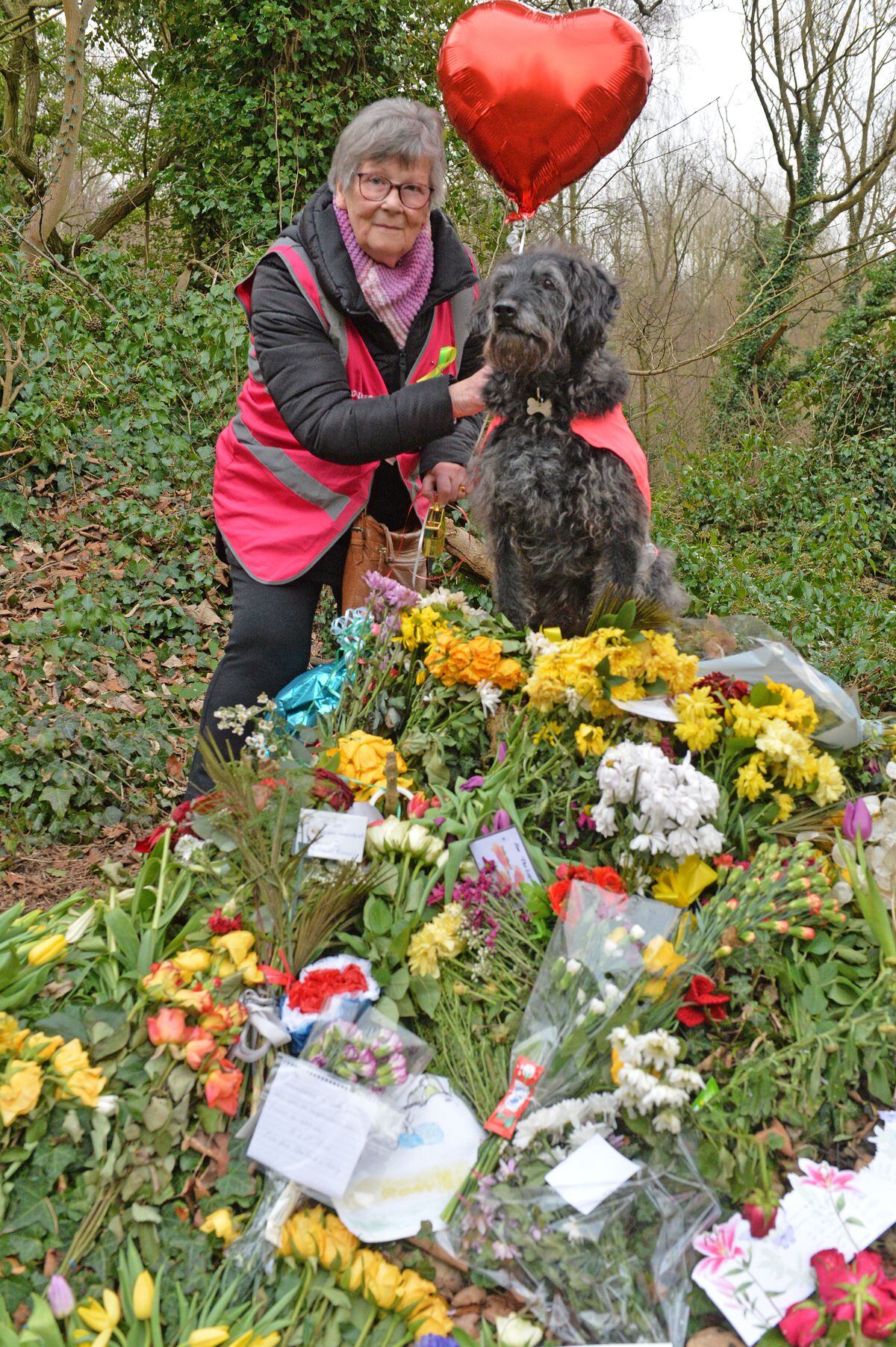 Margaret Jackson with Billy, looking after some of the many floral tributes that have been appearing near the route since Jim's death