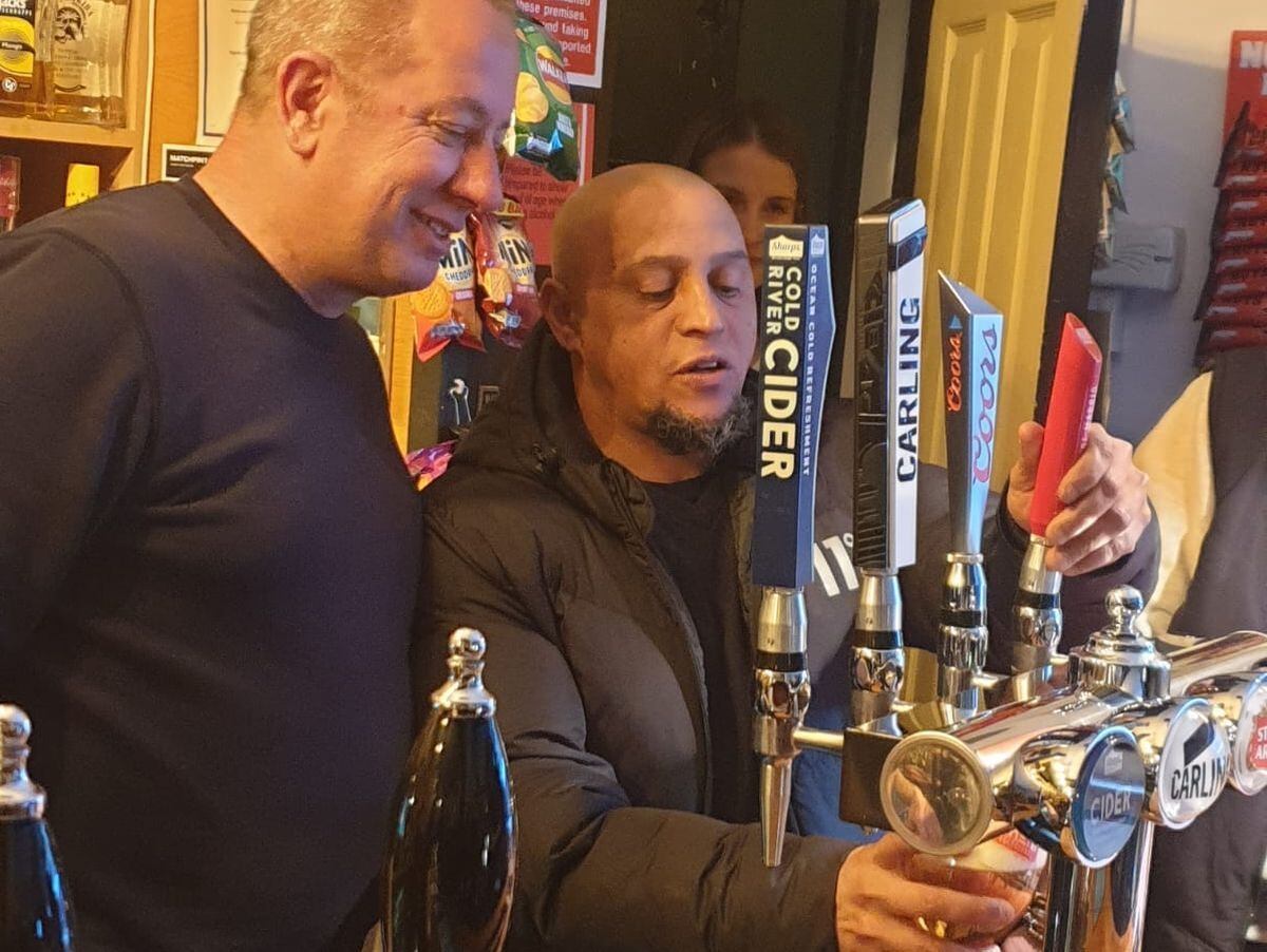 The World Cup winner has a go at pulling his own pint with landlord Richard Dixon