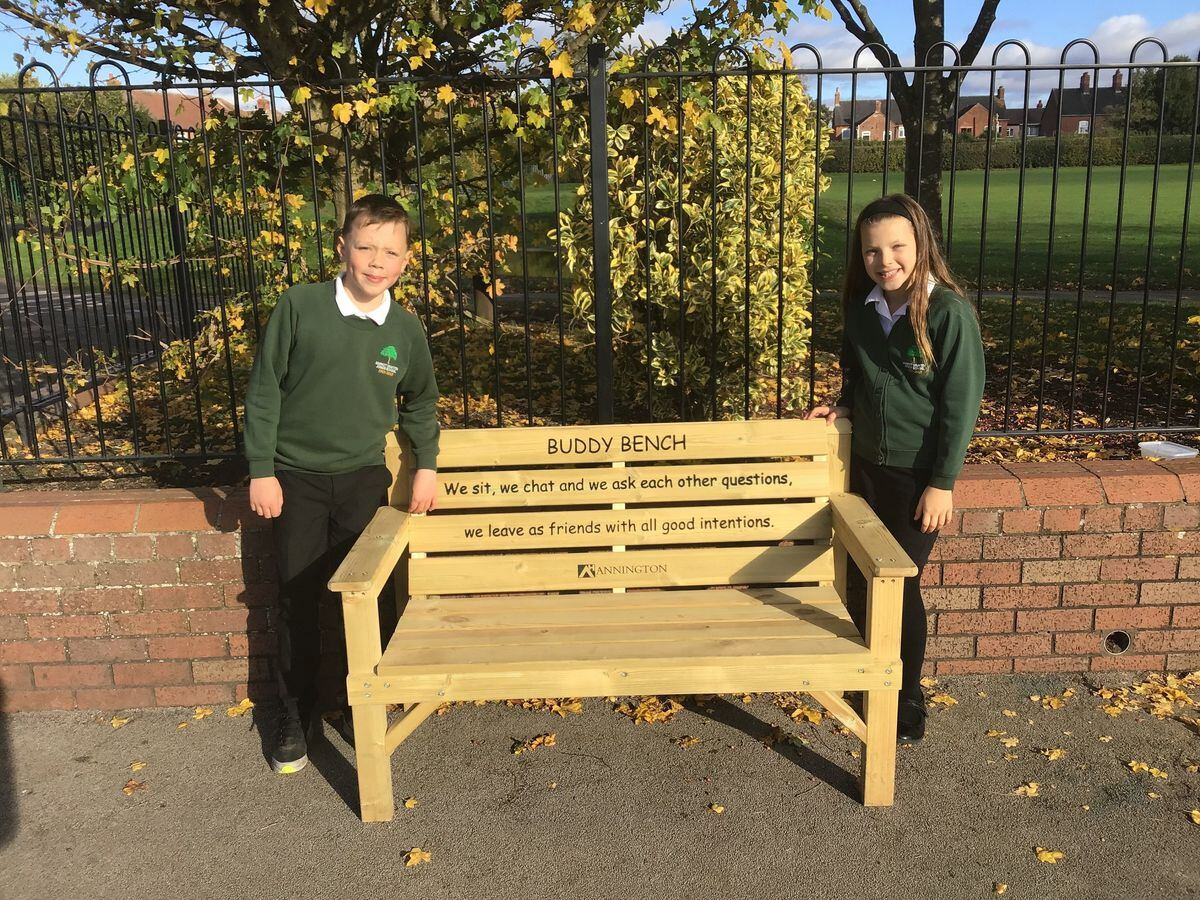 Seth and Kadence with Market Drayton Junior School's new 'buddy bench' 