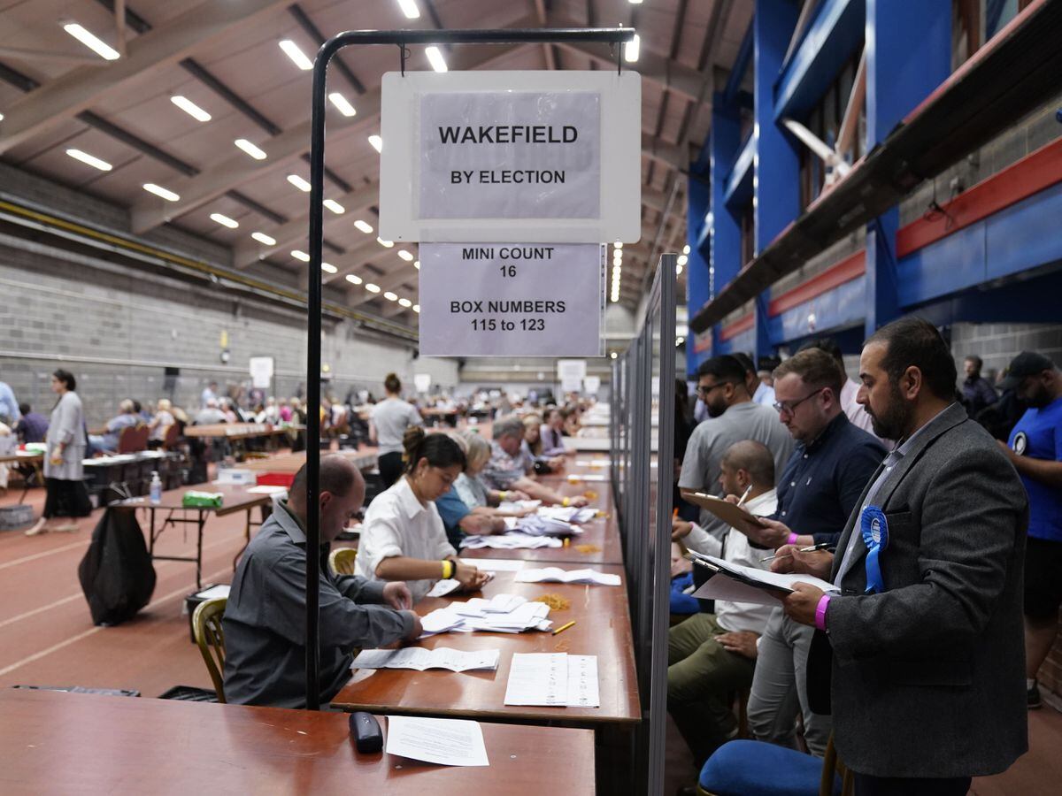 Party officials observe the count at Thornes Park Stadium in Wakefield