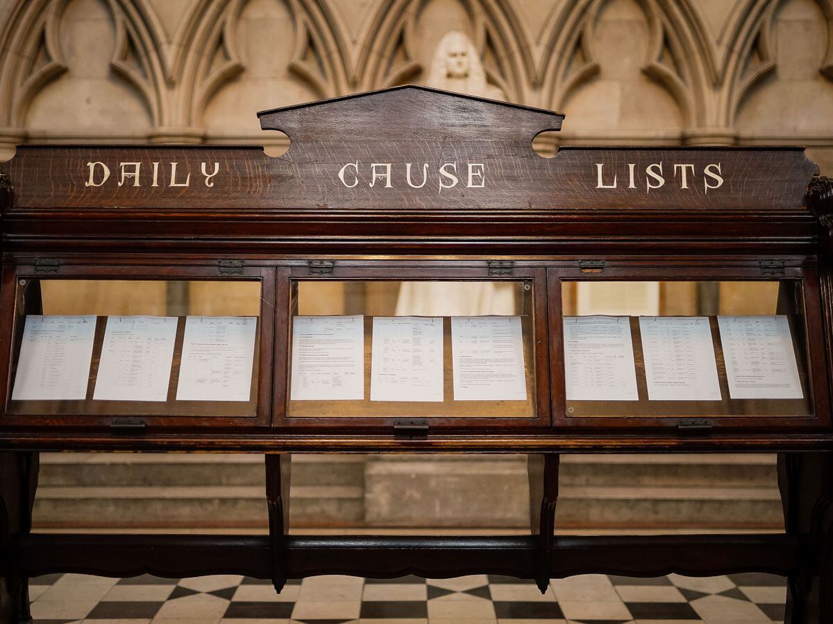 Daily cause list boards inside the main hall at the Royal Courts of Justice