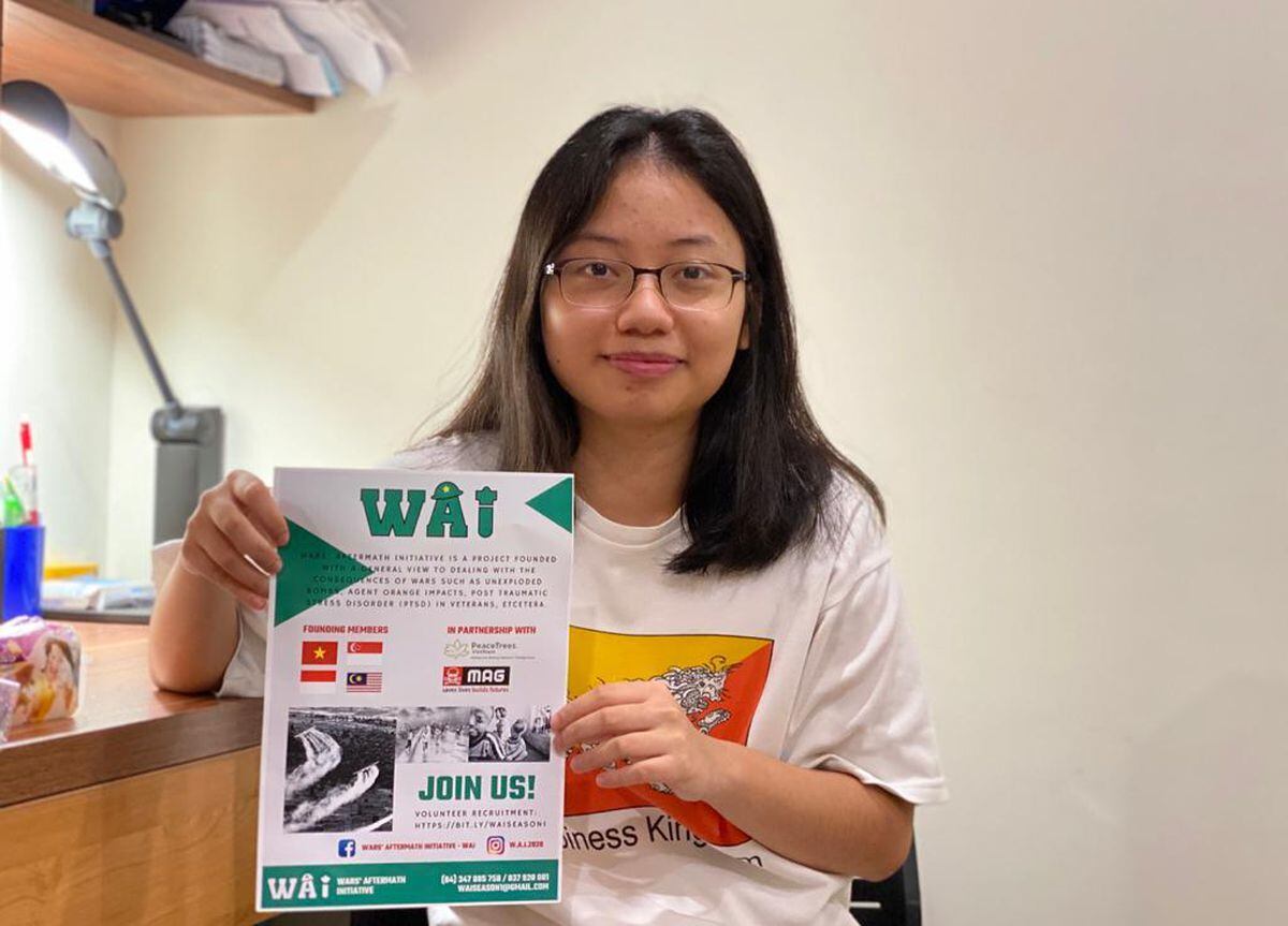 Duong Nguyen with a WAI recruitment poster