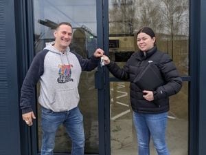 Dean accepted the keys to his new premises from Lucy Groves of Shropshire Council.